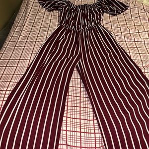Its a burgundy and white striped dressy jumpsuit and its brand is ambiance